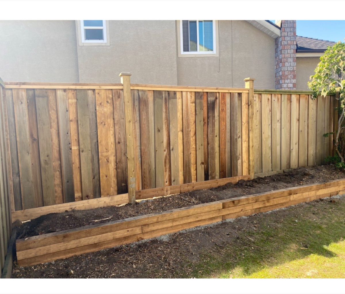 New wood fence with raised garden bed