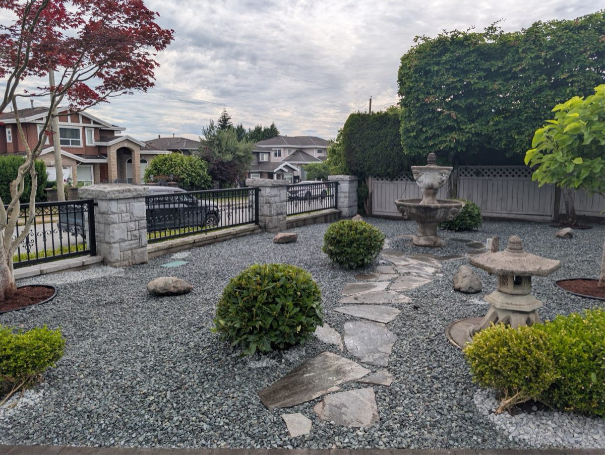 Zen-style rock garden with flagstone path, fountain and stone lanterns